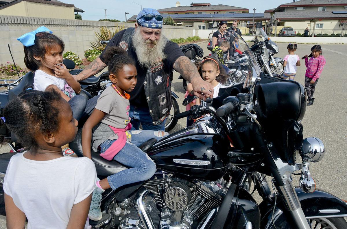 Biker from BACA letting children sit on motorcycle